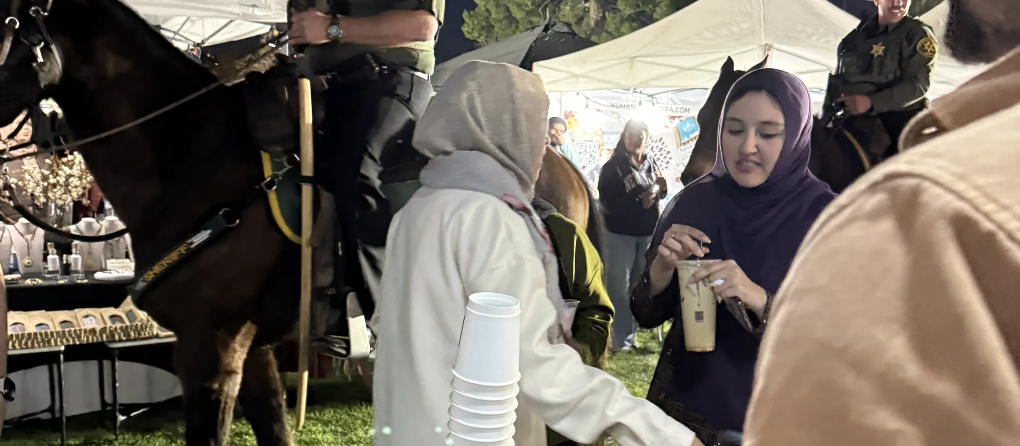 Guests collecting karak chai at an evening outdoor community event