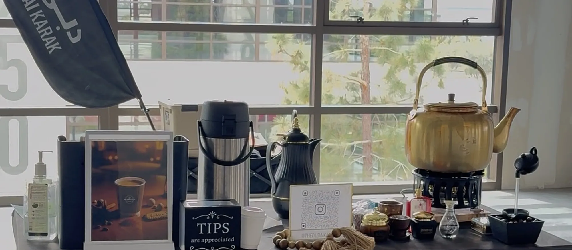 Traditional teapots and brewing equipment on The Dubai Karak service counter