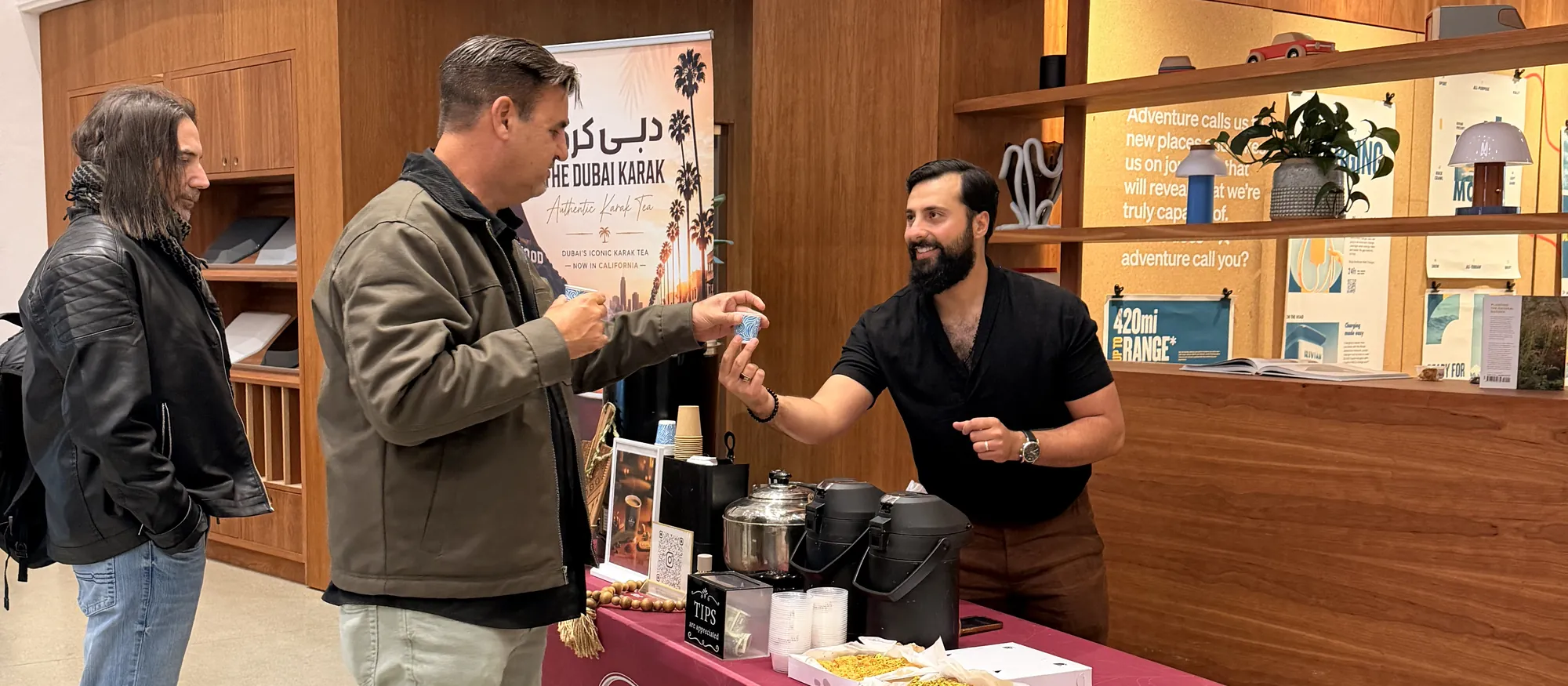 The Dubai Karak maroon branded counter serving guests inside an event venue