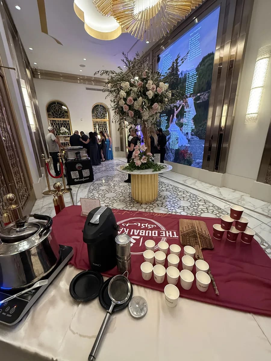 Karak chai cups arranged on the branded counter at a wedding reception
