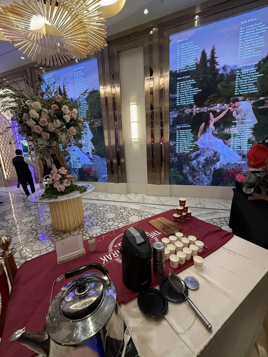 The Dubai Karak tea and coffee station set up beside floral arrangements at an upscale wedding venue